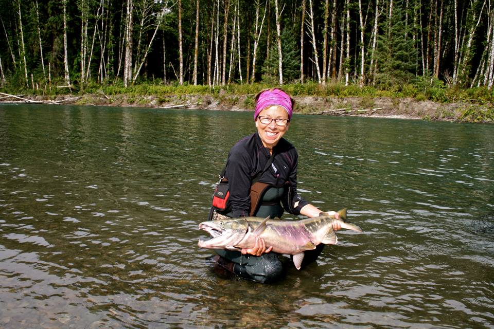 A young woman fly-fishing for trout on the Saloompt River, Bella Coola,  British Columbia Stock Photo